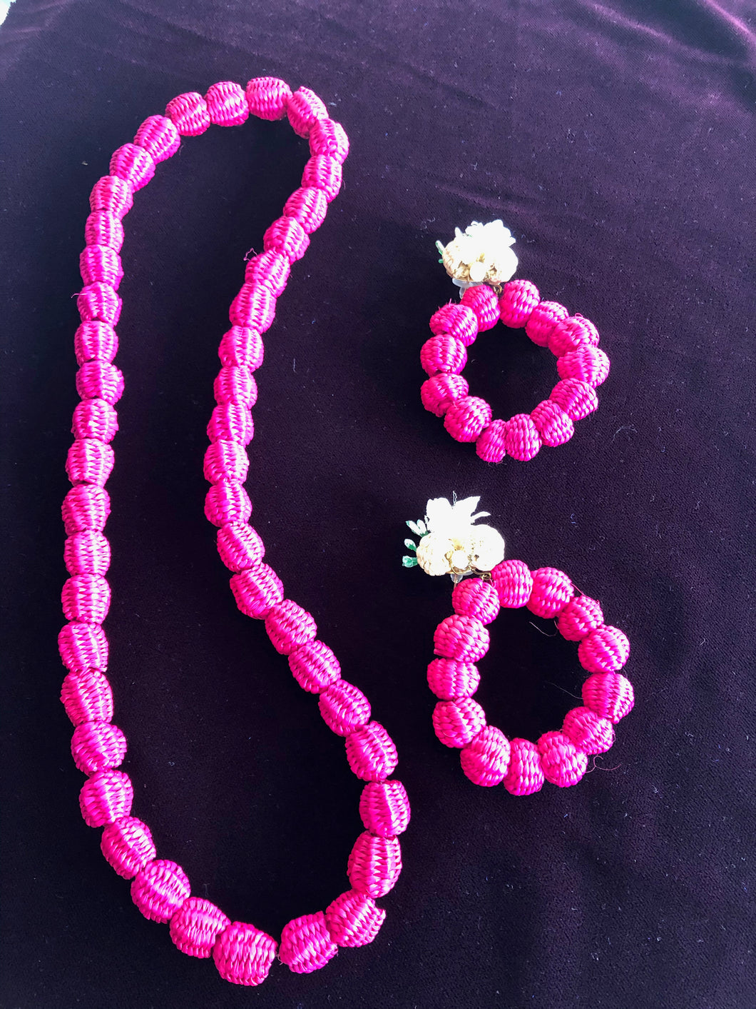 Susie fuchsia paja toquilla necklace and matching large hoop earrings.