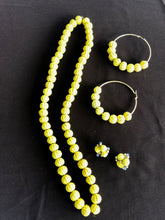 Load image into Gallery viewer, Kelly yellow paja toquilla necklace, large hoop post earrings and small rose earrings.
