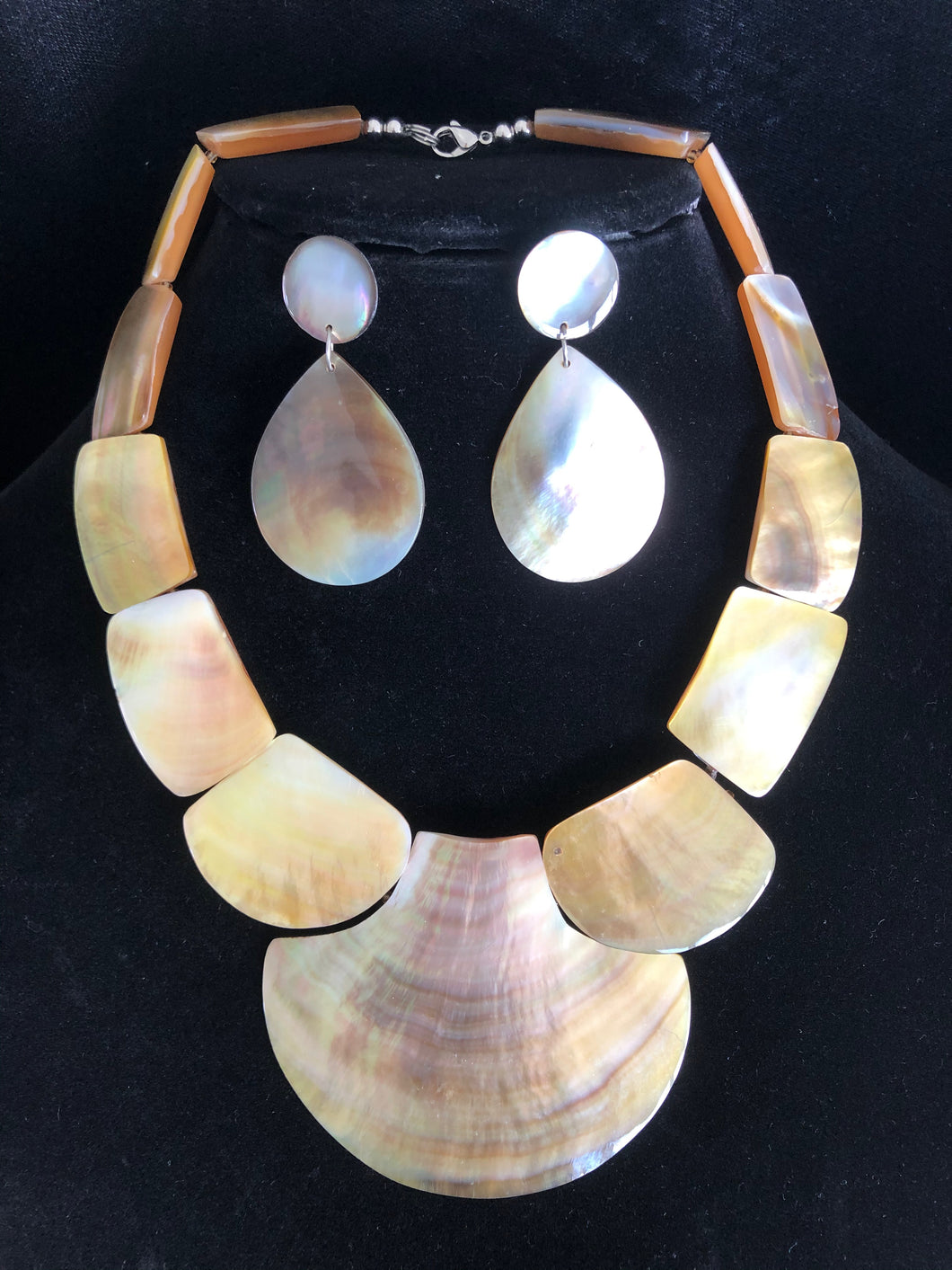 Beige white conch shell pearl necklace and matching earrings.